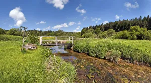 Bridge over the Morsbach stream with green meadows, Altmuhltal Nature Park, Bavaria Bridge over the Morsbach stream with green meadows, Altmuhltal Nature Park, Bavaria