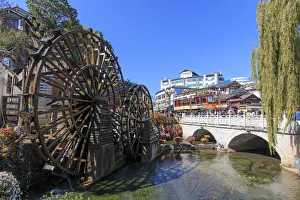 Bridge and Water wheels at the entrance on Lijiang Old Town in Yunnan Bridge and Water wheels at the entrance on Lijiang Old Town in Yunnan