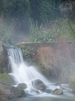 Broken dam in a river with a waterfall and steam Broken dam in a river with a waterfall and steam