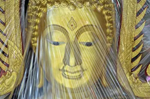 Buddha statue covered with plastic foil, produced in a small factory, Bamrung Muang Road Buddha statue covered with plastic foil, produced in a small factory, Bamrung Muang Road