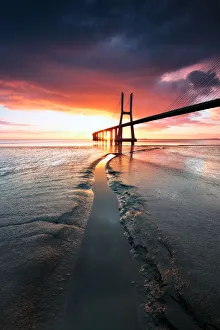 <b class=qtipBold><figcaption>Burning</figcaption></b><br>The Vasco da Gama Bridge is a cable-stayed bridge flanked by viaducts and rangeviews that spans the Tagus River in Parque das Nacoes in Lisbon, capital of Portugal. It is the longest bridge in Europe<br><em>© fredconcha</em> Burning