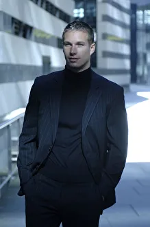 Business man wearing a dark suit in front of a bank building Business man wearing a dark suit in front of a bank building