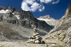 Cairn in Baechlital valley in front of Gross Diamentstock Mountain and Baechli Glacier, Bernese Alps, Switzerland Cairn in Baechlital valley in front of Gross Diamentstock Mountain and Baechli Glacier, Bernese Alps, Switzerland