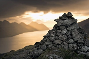 Cairn, dramatic mood lighting over the island of Kunoy, Borooy, Norooyar, Faroe Islands Cairn, dramatic mood lighting over the island of Kunoy, Borooy, Norooyar, Faroe Islands