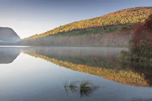 A calm and misty Autumn sunrise in Baxter State Park, Maine, USA A calm and misty Autumn sunrise in Baxter State Park, Maine, USA