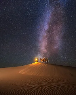 Camel herder under beautiful milky way in Mongolian Gobi desert Camel herder under beautiful milky way in Mongolian Gobi desert
