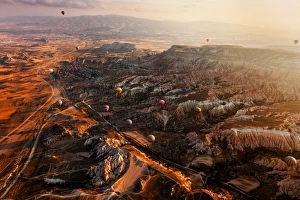 <b class=qtipBold><figcaption>Cappadocia - Scarred Earth</figcaption></b><br>Hot air balloons explore the many canyons making up Goreme National Park - home of the Fairy Chimneys in Cappadocia, Turkey<br><em>© Jon and Tina Reid</em> Cappadocia - Scarred Earth