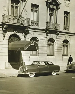 Car standing in front of hotel entrance, (B&W) Car standing in front of hotel entrance, (B&W)