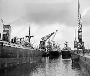<b class=qtipBold><figcaption>Cargo Ships</figcaption></b><br>27th August 1956: Three ships in the flooded King George V dry dock at Southampton being loaded with war material for the Mediterranean. The ship are (left to right) the Rivercrest, the Sandsend and the Sunkirk. (Photo by Derek Berwin/Fox Photos/Getty Images) Cargo Ships