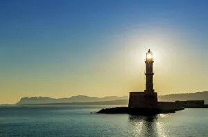 Images Dated 22nd June 2014: Chania lighthouse with the sun right behind, at sunrise, harbour, Chania, Crete, Greece