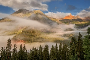 clearing undercast fog at sunrise, alpenglow clearing undercast fog at sunrise, alpenglow