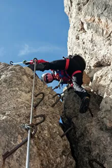 Rising Gallery: Climber on the Masara-Corda Rossa via ferrata, Dolomites, South Tyrol, Italy, Europe