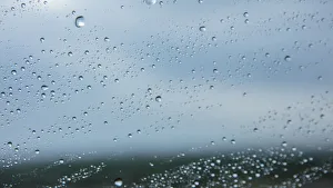 Close up of rain on window with storm clouds in the background, Cape Town, Western Cape Close up of rain on window with storm clouds in the background, Cape Town, Western Cape