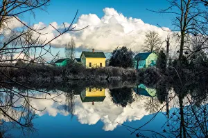 <b class=qtipBold><figcaption>Clouds over the Lake</figcaption></b><br>A beautiful reflection of clouds over a lake on a quite winter's day day. Some surrounding ice is visible on nearby trees. Step back and the pictures takes form similar to a rorschach ink blot.<br><em>© James Lesemann</em> Clouds over the Lake
