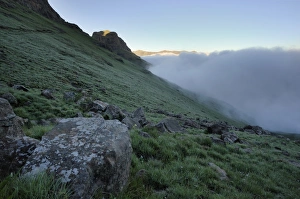 Clouds rising along a grassy slope in the Royal Natal section of the Drakensberg Mountains Clouds rising along a grassy slope in the Royal Natal section of the Drakensberg Mountains