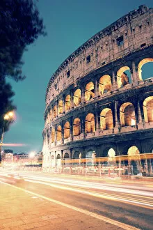 Italia Gallery: Colosseum at night with light trails from cars
