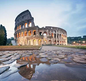 Illuminated Gallery: Colosseum reflected at sunrise, Rome, Italy