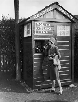 <b class=qtipBold><figcaption>Cool In A Crisis</figcaption></b><br>Circa 1930, A young woman uses the emergency telephone in one of the new miniature police stations installed in Reading, USA. Police, ambulance and fire services can be summoned at a moment's notice. (Photo by FPG/Getty Images) Cool In A Crisis