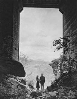 Couple standing in gate, looking at view, (B&W) Couple standing in gate, looking at view, (B&W)