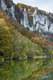 Craggy limestone cliffs with a deciduous forest with autumnal colours in the Danube Craggy limestone cliffs with a deciduous forest with autumnal colours in the Danube