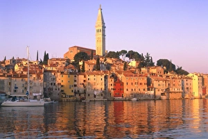 Croatia, Rovinj, church tower & harbour at sunrise seen from water Croatia, Rovinj, church tower & harbour at sunrise seen from water