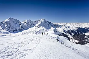 Cross-country skiers descending Hintere Schoentaufspitze Mountain, Solda Cross-country skiers descending Hintere Schoentaufspitze Mountain, Solda