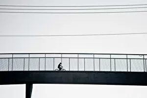 Cyclist crossing bridge