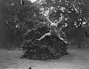 Dancing Dryad, a tunic clad Margaret Morris dancer leaping barefoot over the grass Dancing Dryad, a tunic clad Margaret Morris dancer leaping barefoot over the grass