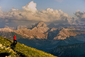 Dark clouds above the Allgau Alps with mountain hiker, Oberstdorf, Bavaria, Germany Dark clouds above the Allgau Alps with mountain hiker, Oberstdorf, Bavaria, Germany