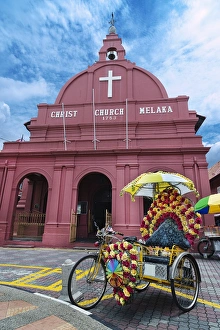 Decorated trishaw in front of Christ Church Melaka Decorated trishaw in front of Christ Church Melaka