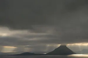 Dramatic mood lighting, low clouds, rays of light falling on the sea, Koltur, Utoyggjar Dramatic mood lighting, low clouds, rays of light falling on the sea, Koltur, Utoyggjar