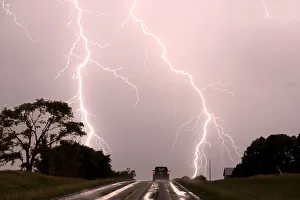 Driving into the storm, Double lightning bolts over highway. Nebraska. USA Driving into the storm, Double lightning bolts over highway. Nebraska. USA