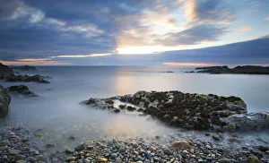 Early morning landscape of ocean over rocky shore with glowing sunrise - Findochty Early morning landscape of ocean over rocky shore with glowing sunrise - Findochty