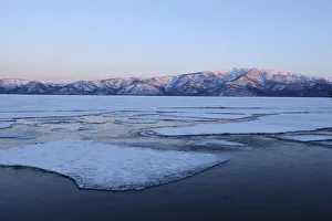 Early morning mood on the frozen Lake Kussharo with ice floes in the front Early morning mood on the frozen Lake Kussharo with ice floes in the front