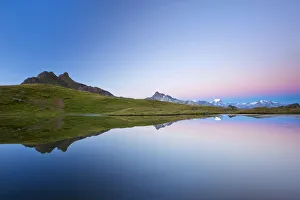 Early morning mood on Lake Berglimatt with a reflection of the Glarus Alps Early morning mood on Lake Berglimatt with a reflection of the Glarus Alps