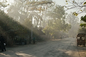 Early morning on a village road, sun rays, Ngapali Beach, Thandwe, Myanmar Early morning on a village road, sun rays, Ngapali Beach, Thandwe, Myanmar