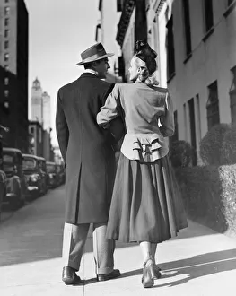 Elegant couple walking on street, (Rear view) (B&W) Elegant couple walking on street, (Rear view) (B&W)