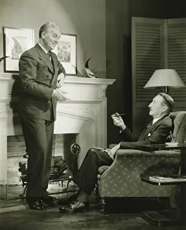 Two elegant men talking by fireplace, (B&W) Two elegant men talking by fireplace, (B&W)
