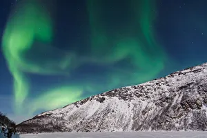 <b class=qtipBold><figcaption>The Embryo</figcaption></b><br>Northern Lights (Aurora Borealis) over GrotfjAžrd, KvalAžya (lit. Whale Island). KvalAžya is a montainous island located in Troms county in northern Norway. Moonlit, snowcapped mountains.<br><em>© Krzysztof Baranowski</em> The Embryo