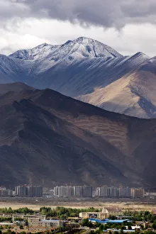 The enormous mountain range and the new city of Lhasa The enormous mountain range and the new city of Lhasa