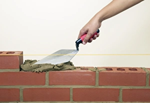 Evening off mortar on bricks with a trowel Evening off mortar on bricks with a trowel