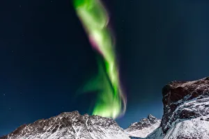 <b class=qtipBold><figcaption>Evolving Lights</figcaption></b><br>Northern Lights (Aurora Borealis) over GrotfjAžrd, KvalAžya (lit. Whale Island).KvalAžya is a montainous island located in Troms county in northern Norway.Moonlit, snowcapped mountains.<br><em>© 2015 Krzysztof Baranowski</em> Evolving Lights