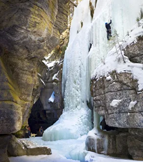 Family watching an ice climber on a frozen waterfall, Jasper National Park, Alberta Family watching an ice climber on a frozen waterfall, Jasper National Park, Alberta