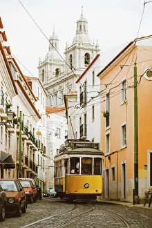 Lisbon Collection: Famous yellow tram on the narrow streets of Alfama district, Lisbon, Portugal