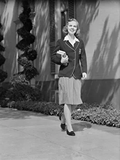 Female student walking outside school, portrait Female student walking outside school, portrait