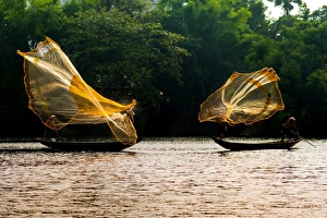 Fishermen catch fish in the river in Hue, Vietnam Fishermen catch fish in the river in Hue, Vietnam