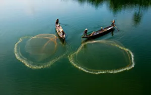 Fishermen go fishing on two boats in Hue, Vietnam Fishermen go fishing on two boats in Hue, Vietnam