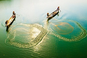 Fishing men on boat in river in Hue, Vietnam Fishing men on boat in river in Hue, Vietnam