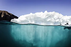 <b class=qtipBold><figcaption>Floating</figcaption></b><br>A small iceberg is being investigated by divers on a sunny summers day.Image was taken in the Westfjord area on the east coast of Greenland.<br><em>© Wildestanimal 2015</em> Floating