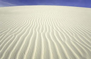 Flowing patterns and shapes created by wind on white gypsum sand dunes Flowing patterns and shapes created by wind on white gypsum sand dunes
